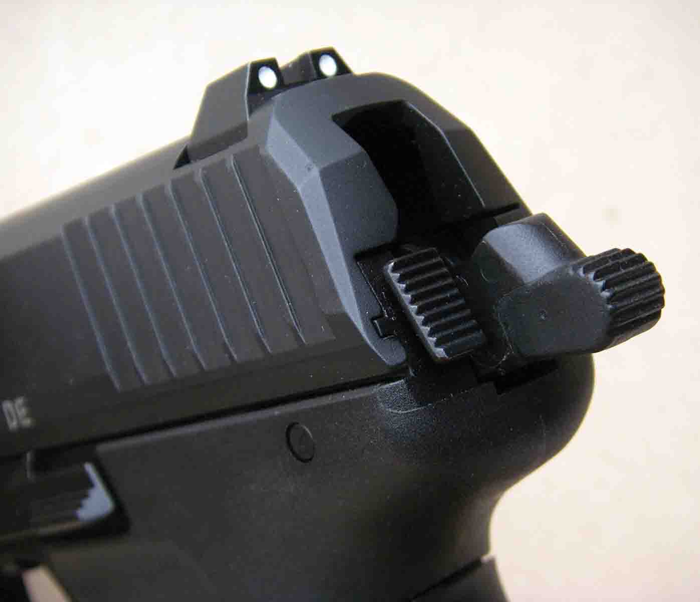Robust sights are dovetailed into the slide and provide a three-dot system. The decocking button is located to the left of the hammer. Its location also serves to make the sides of the pistol snag free.